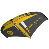 A wingfoil wing shown from a side angle on a plain white background. The wing features a bold yellow and dark gray/black graphic design with white accents and yellow branding text.