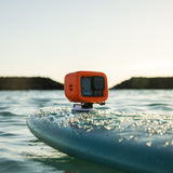 GoPro 13 black with floaty attached to surf board with adhesive mount