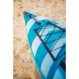 Close-up of a blue and white kayak on sandy ground