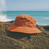Burnt Orange wide brimmed surf hat with surfshell branding logo and a protective bump shell on inside