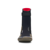 A single minimalist wetsuit boot shown from the front on a clean white background. The boot features a black neoprene upper, a bright red interior lining at the ankle opening, a textured brownish-gray sole, and white branding saying 'c-skins'